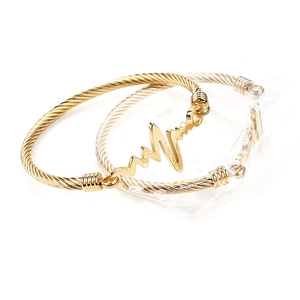 Detail of gold EKG pulse heart rate bangle bracelets made of durable stainless steel