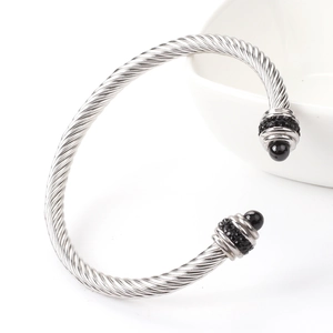 Detail of twisted cable silver bangle with black beads and inlaid sparkling rhinestones