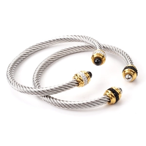 Detailed close-up of twisted cable bracelets with pave rhinestones and gold accents