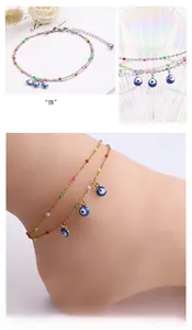 Macro detail of gold-plated double-layer evil eye anklet with colorful beads and charms