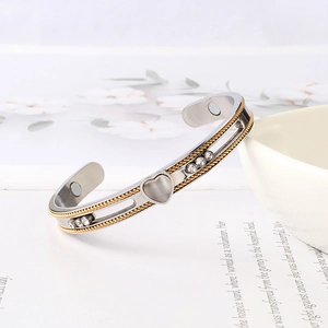 Detail of magnetic titanium cuff with heart charm, opal inlay and silver brushed texture