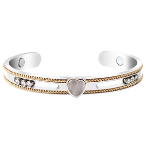 Macro detail of magnetic therapy steel cuff with cat eye heart and embedded inner magnets