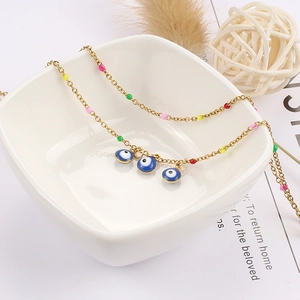 Gold evil eye anklet with colorful beads and triple Mediterranean style charms