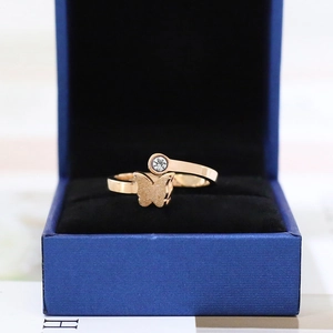 Detail of rose gold butterfly ring with sandblasted finish and round clear zircon
