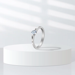 Detailed view of silver ring with round white zircon on a modern display stand