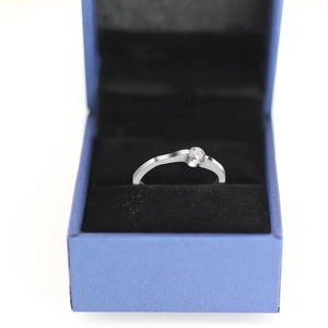 Detailed view of single round zircon solitaire ring in classic silver finish box