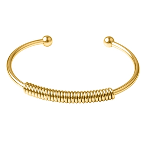 Detailed close-up of golden spring cuff bracelet showing spiral coil texture and ball ends