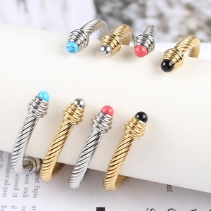 Macro shot of twisted wire cable open bracelets with colorful stone end beads