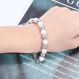 Women's pearl and silver bead bracelet on hand with modern mixed chain detail