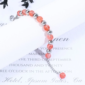 Detail of beaded bracelet with orange crackle glass beads and silver lobster clasp closure