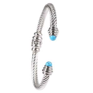 Silver twisted cable open cuff bracelet with blue stone ends in 18K gold style