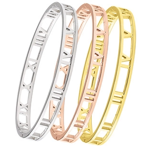 Detail of three-piece stainless steel bracelets with cutout Roman numeral design