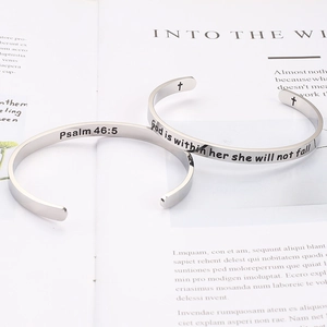 Detail showing engraved Bible verses and cross on silver stainless steel cuff bracelet