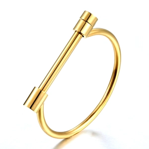 Polished 18K gold stainless steel bangle featuring a modern horseshoe D-buckle design