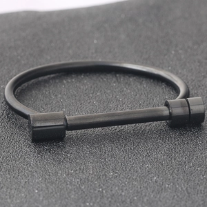 Detail of black matte stainless steel horseshoe bangle with D-shackle screw closure