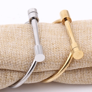 Detail of silver and gold horseshoe screw bracelets on a linen display roll