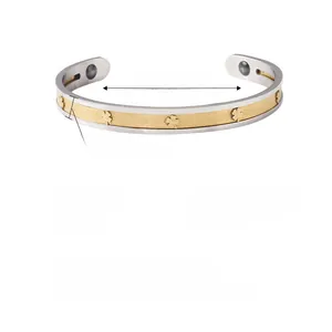 Detailed view of 66mm diameter stainless steel C-shaped bangle with clover relief