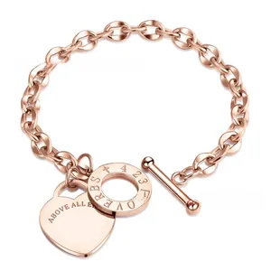 Detailed macro view of rose gold OT buckle and heart charm on stainless steel chain