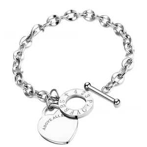 Detail of silver stainless steel chain bracelet with OT toggle and heart charm