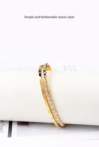 Detail view of rose gold roman numeral bangle with shimmering pave crystals and dual layer