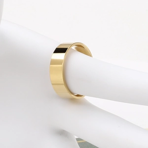 Detailed close-up of 6mm polished gold stainless steel flat ring on a white hand model