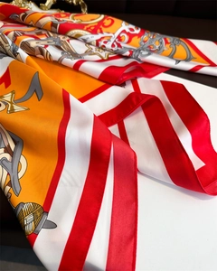 Detail of silk-like scarf with vintage chain patterns and luxury satin texture folds
