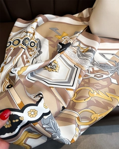 Detail of silk square scarf featuring vintage chain and baroque patterns on soft fabric
