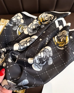 Detail of camellia floral print silk scarf with luxury texture and elegant draping