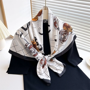Elegant 90cm camellia silk scarf with black border and floral pattern on garment