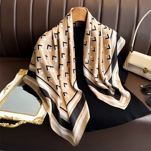 Elegant 90cm square silk scarf with geometric patterns on a wooden hanger