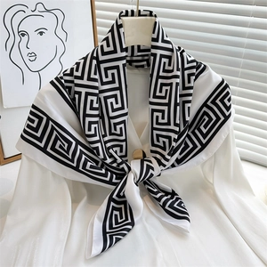 Elegant 90cm silk scarf with black Greek Key print on white satin, styled with gold ring