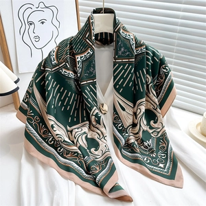 Close-up of vintage emerald green silk scarf with baroque floral and geometric patterns