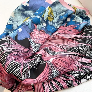 Silk-textured scarf with blue floral and koi prints in soft 90cm square folds