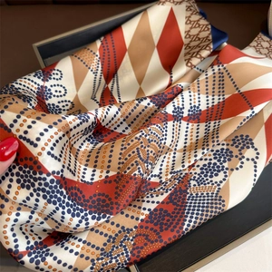 Macro detail of silk-like scarf featuring diamond pattern and elegant polka dot prints