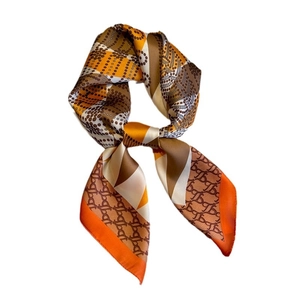 Elegant diamond-pattern silk-like square scarf in orange, brown, and white geometric design