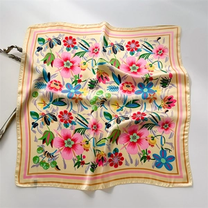 Detailed view of floral satin silk square scarf with vibrant botanical print and glossy finish