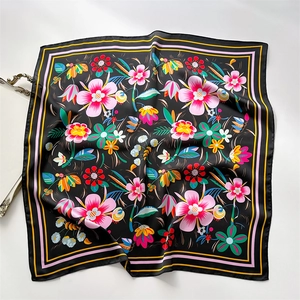 Detail of floral geometric print silk scarf with satin finish on elegant silver tray