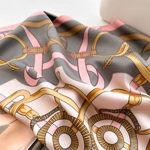 Detail of vintage chain print silk scarf showing satin texture and equestrian motifs