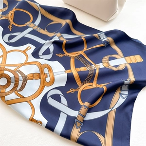 Detail of nautical chain print silk scarf with equestrian horse bit pattern texture