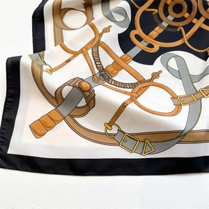 Macro shot of vintage chain print silk scarf with classic equestrian golden patterns