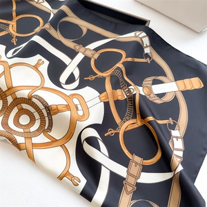 Detailed view of luxury equestrian chain print on smooth silk-feel satin square scarf