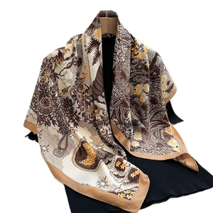 Sunflower pattern twill silk scarf for women in brown and yellow hanging on a hanger
