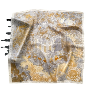 Golden silk square scarf with tropical jungle and architectural print in a flat lay view