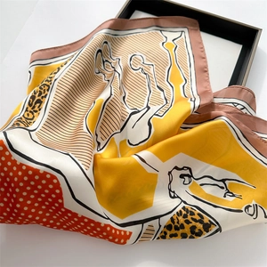 Detail of silk-like square scarf featuring leopard horse print and ginger orange accents