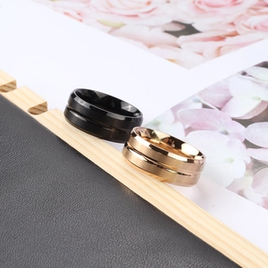 Minimalist matte stainless steel rings for men in black and gold with center groove
