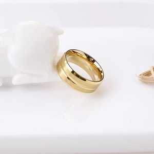 Macro shot of wide gold titanium steel ring with parallel double groove minimalist design