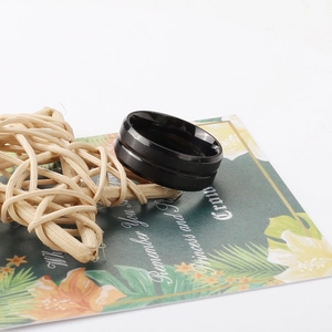Detail shot of a black stainless steel wide ring with double groove design and sand finish