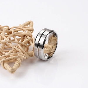 Macro detail of silver titanium ring with brushed texture and polished double grooves