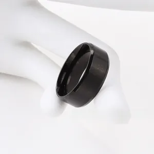 Macro detail of a wide black stainless steel ring with a textured matte starry finish