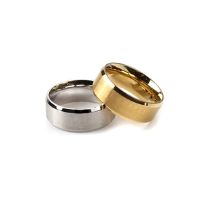 Macro detail of gold and silver couple rings with brushed finish and polished edges